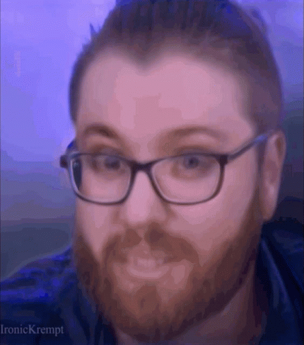 A Man With Glasses And A Beard Is Making A Face GIF