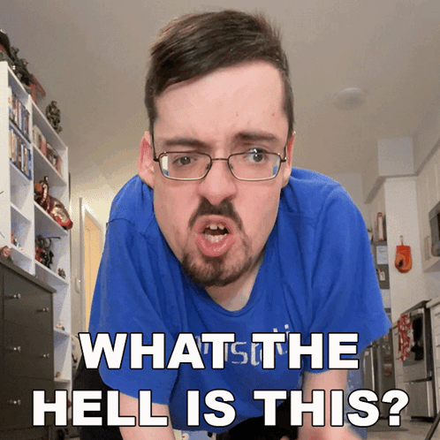 A Man With Glasses And A Beard Is Making A Funny Face And Says " What The Hell Is This " GIF