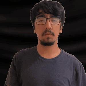 a man with glasses and a beard is making a gesture with his hand
