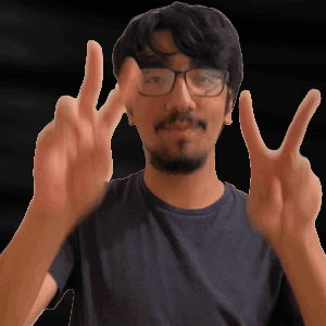 A Man With Glasses And A Beard Is Making A Peace Sign GIF