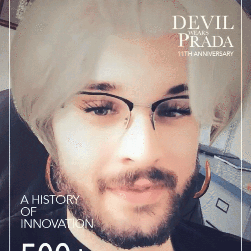 A Man With Glasses And A Beard Is On A Devil Wears Prada Poster GIF