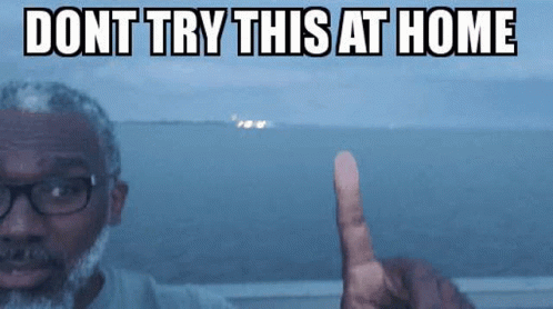 A Man With Glasses And A Beard Is Pointing At Something With The Words " Dont Try This At Home " Written Above Him GIF