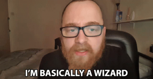 a man with glasses and a beard is saying i 'm basically a wizard