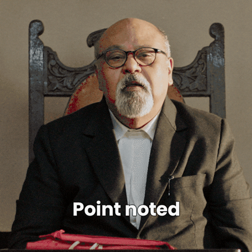 A Man With Glasses And A Beard Is Sitting In A Chair With The Word Point Noted Written Below Him GIF