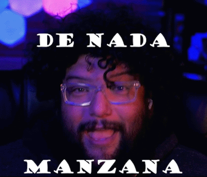 A Man With Glasses And A Beard Is Sitting In A Chair With The Words De Nada Manzana Above Him GIF