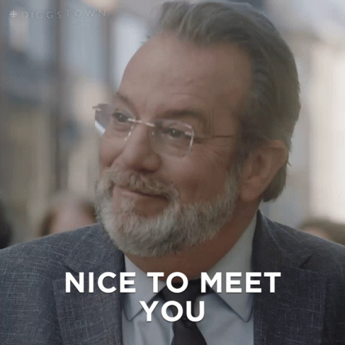 A Man With Glasses And A Beard Is Smiling And Says Nice To Meet You GIF