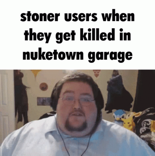 A Man With Glasses And A Beard Is Standing In Front Of A Sign That Says Stoner Users GIF