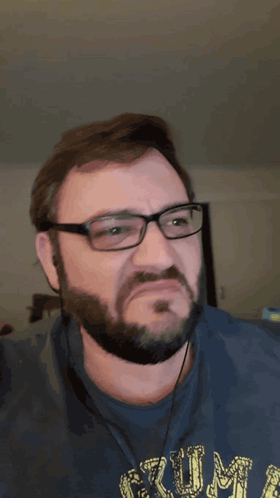 A Man With Glasses And A Beard Is Wearing A Blue Shirt With The Word Rum On It GIF
