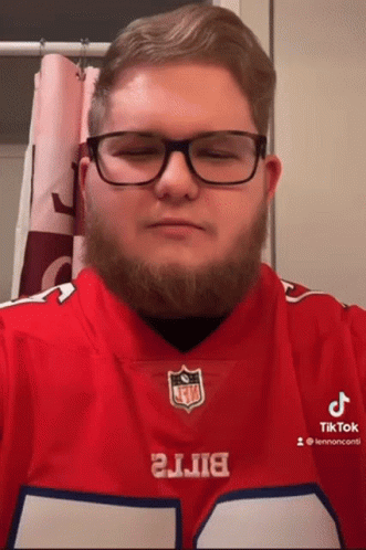 A Man With Glasses And A Beard Is Wearing A Buffalo Bills Shirt GIF