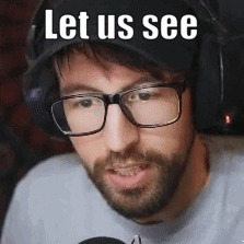 A Man With Glasses And A Beard Is Wearing A Hat And Headphones And Says `` Let Us See '' . GIF