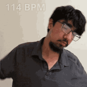 A Man With Glasses And A Beard Is Wearing A Shirt That Says 114 Bpm On It GIF