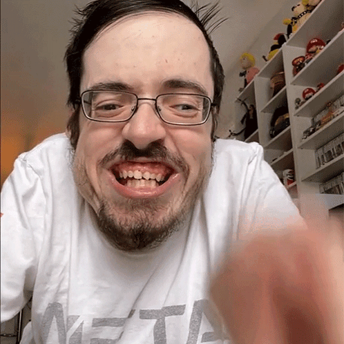 A Man With Glasses And A Beard Is Wearing A Shirt That Says Meta GIF