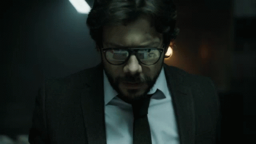 A Man With Glasses And A Beard Is Wearing A Suit GIF