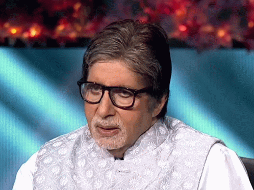 A Man With Glasses And A Beard Is Wearing A White Shirt GIF