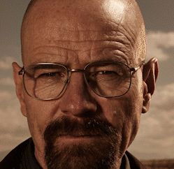 A Man With Glasses And A Beard Looks At The Camera With A Cloudy Sky In The Background GIF
