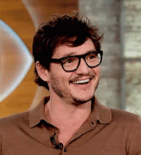 A Man With Glasses And A Beard Smiles For The Camera GIF