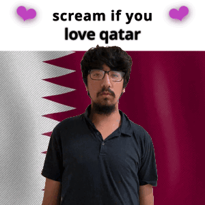 A Man With Glasses And A Beard Stands In Front Of A Qatar Flag GIF