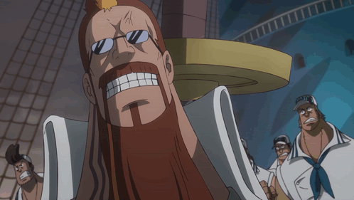 A Man With Glasses And A Beard Stands In Front Of A Sign That Says " G.o.t. " GIF