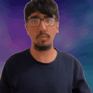 a man with glasses and a beard waves his hand in front of a purple background