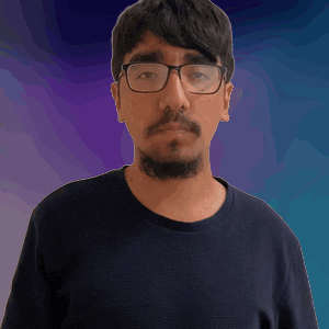 A Man With Glasses And A Beard Wearing A Black Shirt GIF