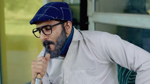 A Man With Glasses And A Beard Wearing A Blue Hat GIF