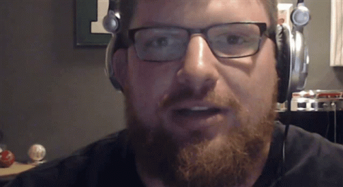 a man with glasses and a beard wearing headphones