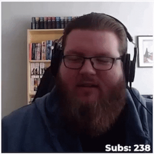A Man With Glasses And A Beard Wearing Headphones With The Number 238 On The Bottom Right GIF