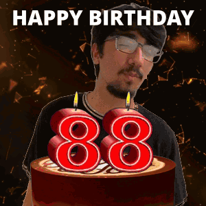 A Man With Glasses And A Birthday Cake With Candles In The Shape Of 88 GIF