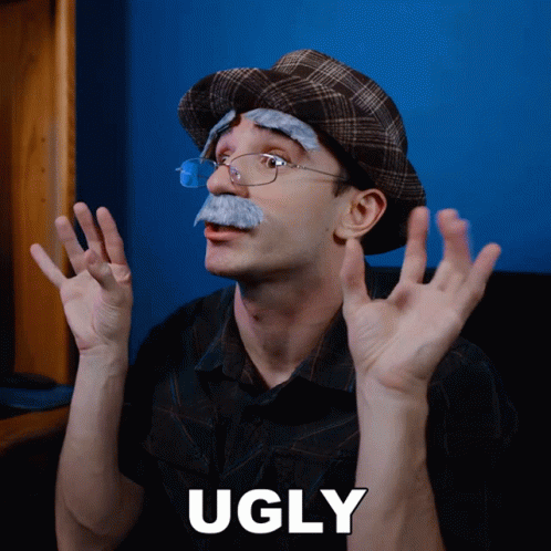A Man With Glasses And A Fake Mustache Has The Word Ugly On The Bottom GIF