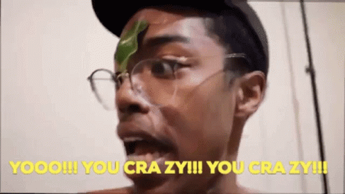 A Man With Glasses And A Green Leaf On His Face Says " You Crazy !!! " GIF