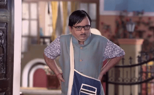 A Man With Glasses And A Mustache Is Holding A Blue Bag That Says ' Id ' On It GIF
