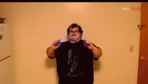 A Man With Glasses And A Mustache Is Holding A Purple Object In Front Of A Wall With Failtube Written On It GIF