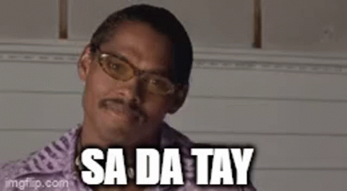 A Man With Glasses And A Mustache Is Smiling With The Words `` Sa Da Tay '' Above Him . GIF