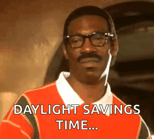 A Man With Glasses And A Mustache Is Wearing A Shirt That Says Daylight Savings Time GIF
