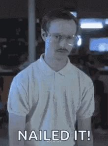 A Man With Glasses And A Mustache Is Wearing A White Polo Shirt And Saying `` Nailed It '' . GIF