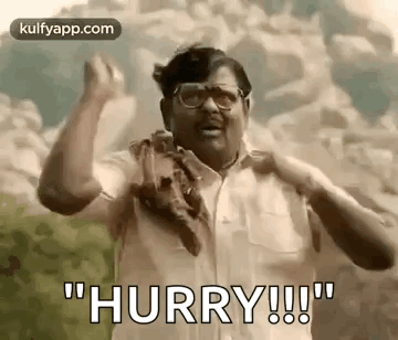 A Man With Glasses And A Scarf Around His Neck Is Making A Funny Face And Saying `` Hurry ! '' GIF