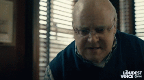 A Man With Glasses And A Sweater That Says The Loudest Voice GIF