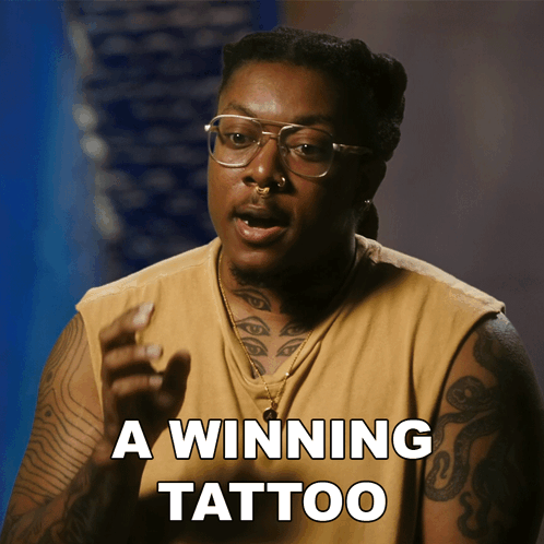A Man With Glasses And A Tattoo On His Arm Says " A Winning Tattoo " GIF