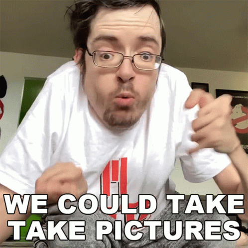 A Man With Glasses And A White Shirt That Says We Could Take Pictures On It GIF