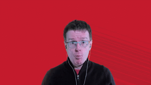 a man with glasses and headphones says wow in front of a striped background