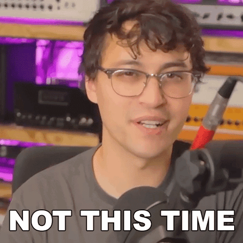 A Man With Glasses Is Holding A Microphone And Saying Not This Time . GIF