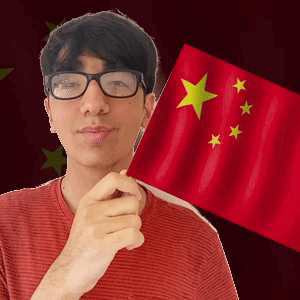 A Man With Glasses Is Holding A Red Flag With Yellow Stars On It GIF