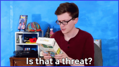 A Man With Glasses Is Holding A Wii Phone In His Hands And Asking Is That A Threat GIF