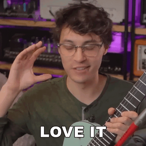A Man With Glasses Is Playing A Guitar And Says Love It GIF
