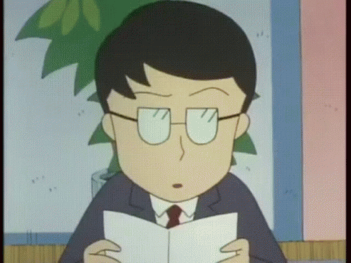 A Man With Glasses Is Reading A Book GIF