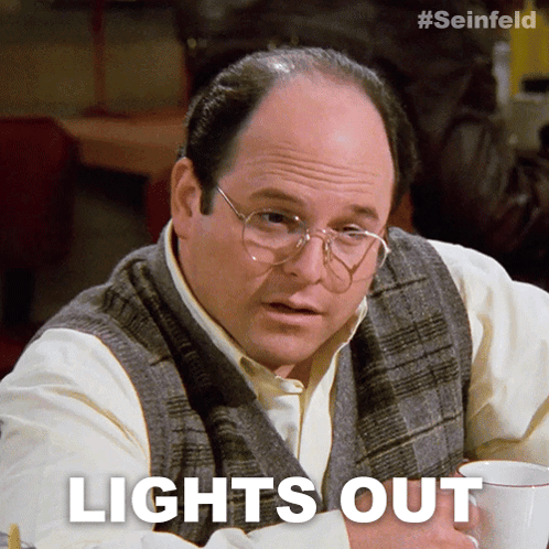 a man with glasses is sitting at a table with a cup of coffee and the words lights out above him