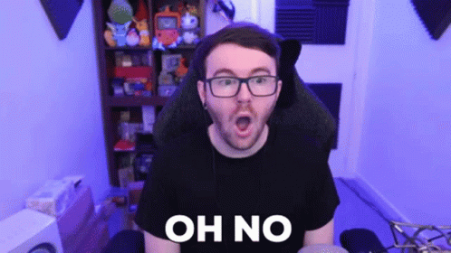 A Man With Glasses Is Sitting In A Chair With His Mouth Open And The Words Oh No Written On His Chest . GIF