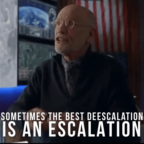 a man with glasses is sitting in front of a sign that says sometimes the best deescalation is an escalation