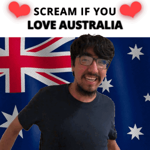 A Man With Glasses Is Smiling In Front Of An Australian Flag And A Sign That Says Scream If You Love Australia GIF