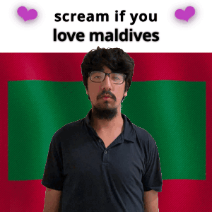 A Man With Glasses Is Standing In Front Of A Maldives Flag GIF